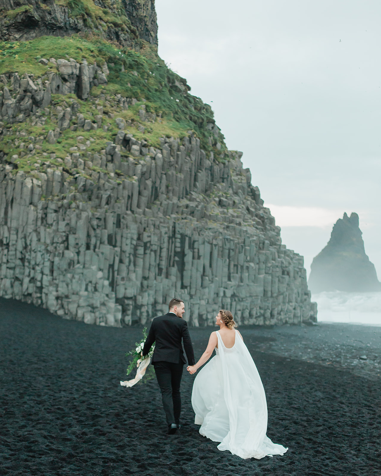 See Michael & Nicole's Iceland beach elopement on Iceland's South Coast, with waterfalls, black sand beaches, and planning inspiration.