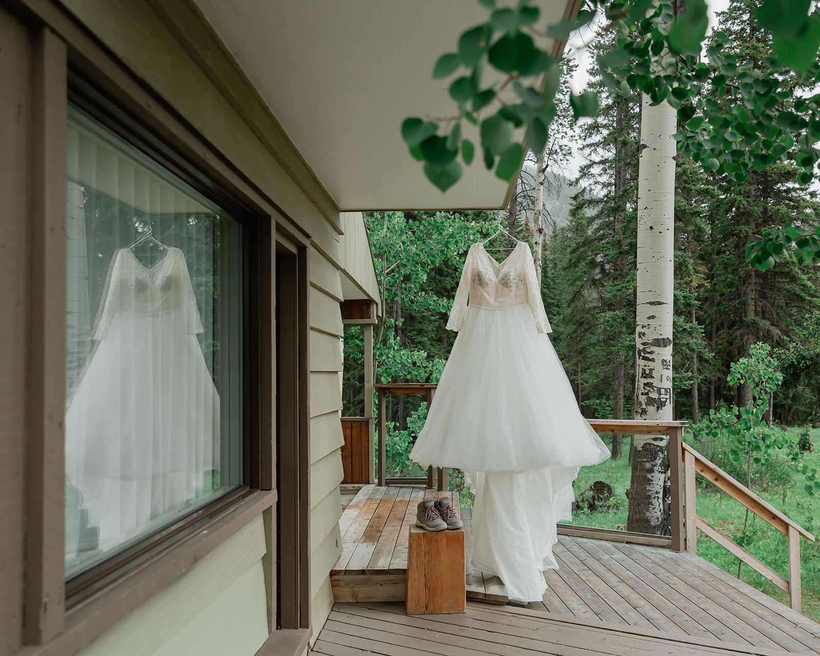 Wedding dress hanging outside the Juniper Hotel in Banff during preparations for a Lake Minnewanka elopement.