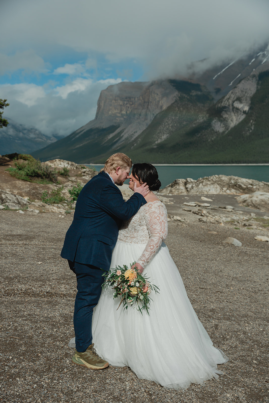 See Rachel and Russell’s Lake Minnewanka elopement, from an intimate Banff ceremony and rainbow to Two Jack Lake, dancing, and star photos.