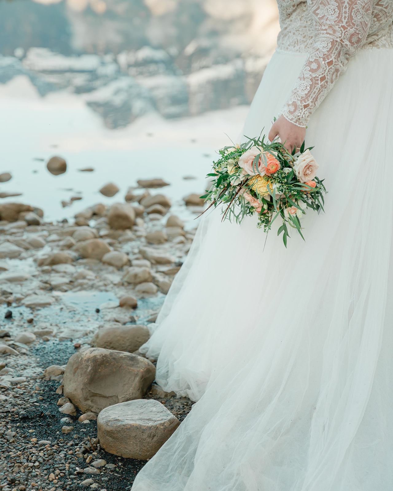 See Rachel and Russell’s Lake Minnewanka elopement, from an intimate Banff ceremony and rainbow to Two Jack Lake, dancing, and star photos.